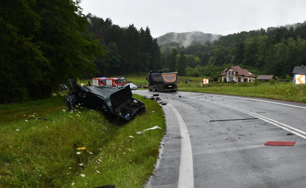 Dwa rozbite samochody na łuku drogi